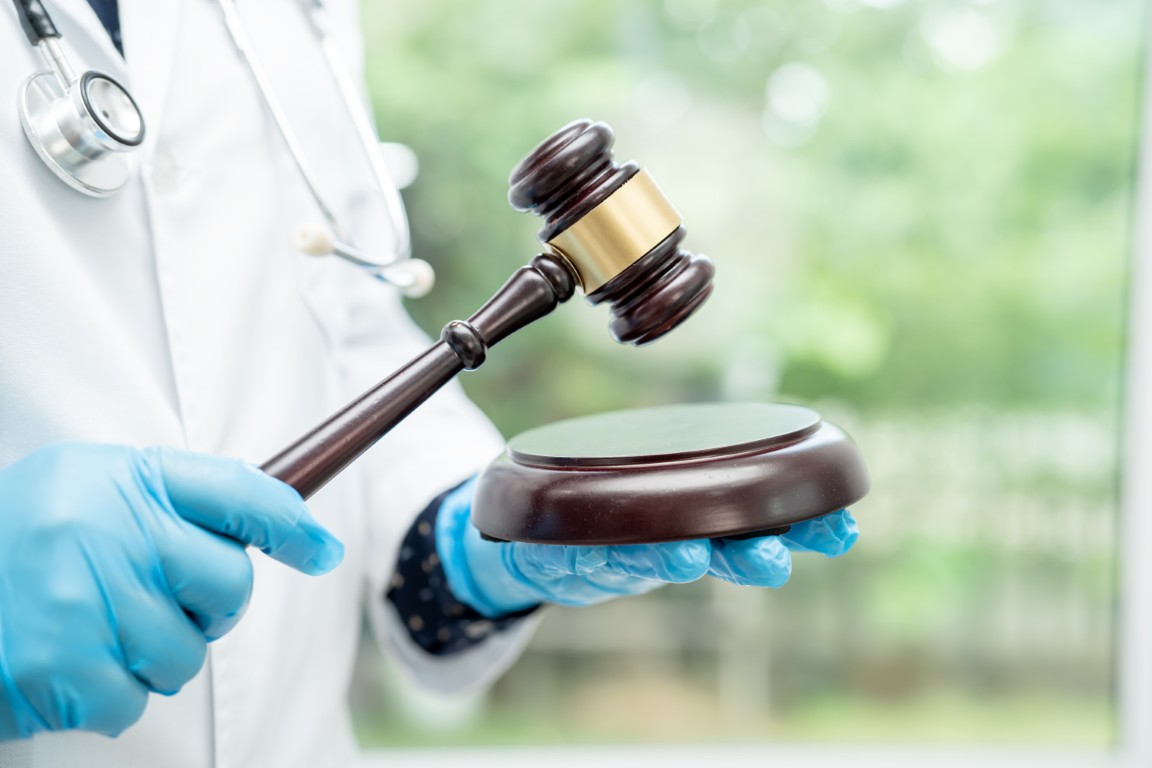 A doctor holding a judge's gavel
