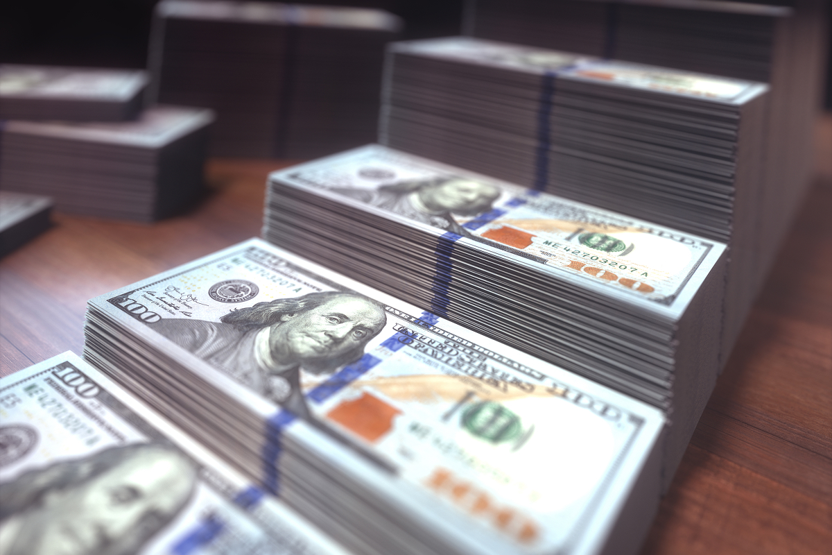 Stacks of dollar bills going up in a graph-like shape