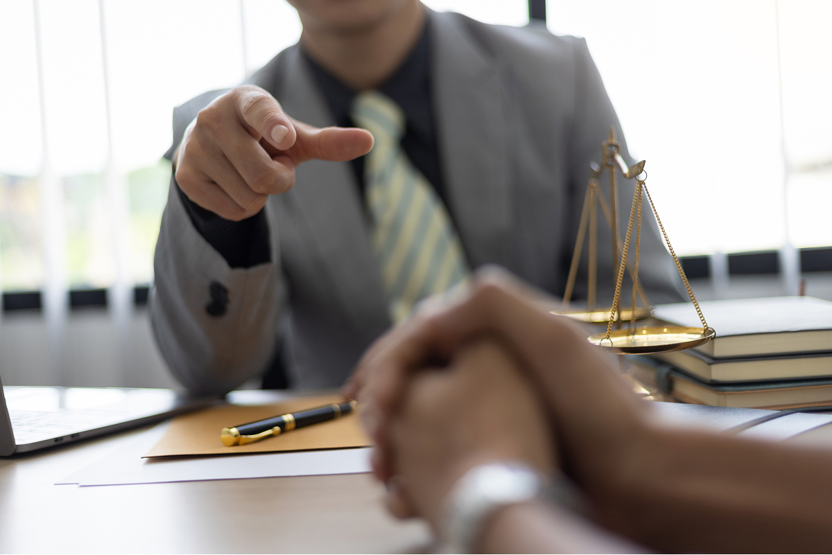 A lawyer speaking with a client in a well-lit office