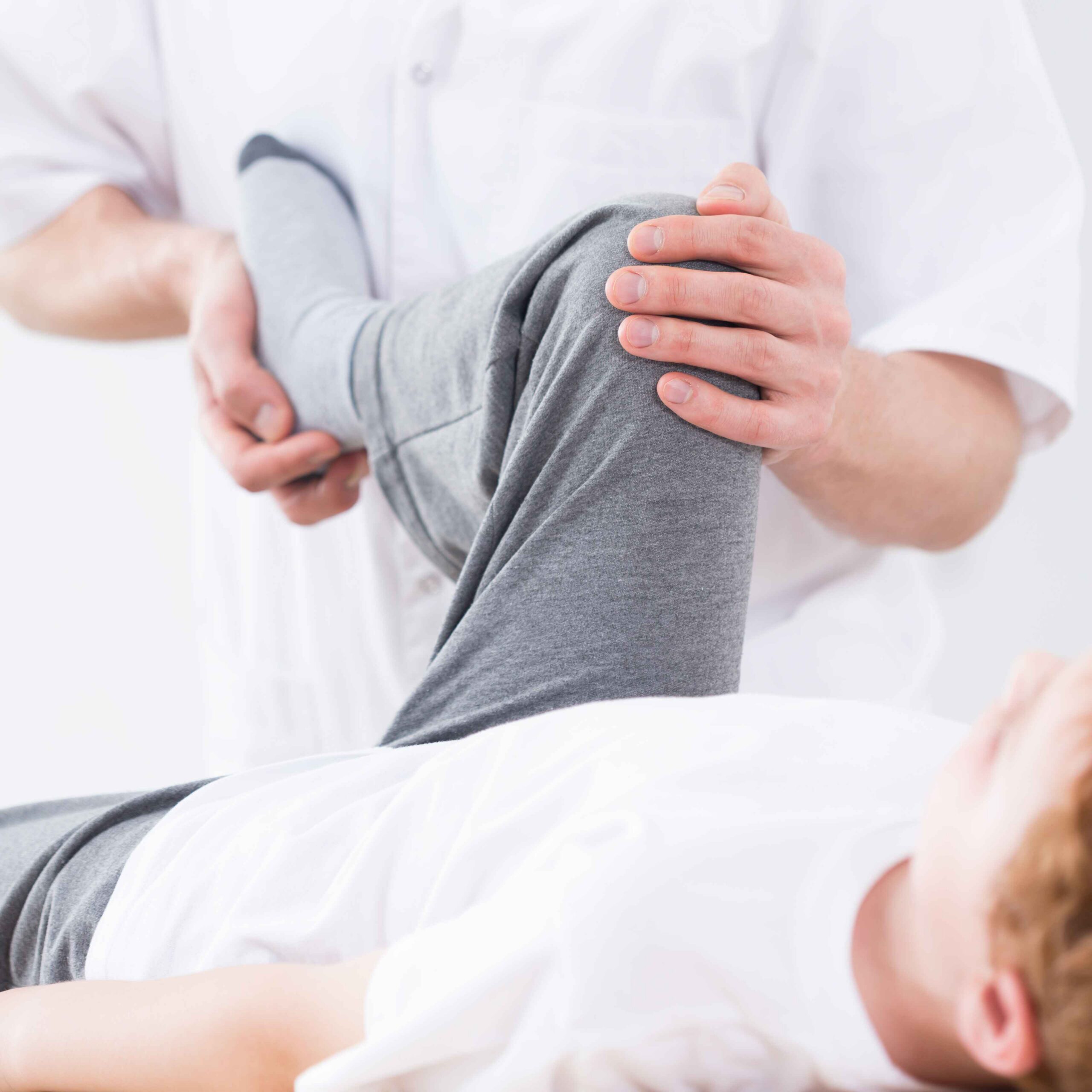 A man receiving physical therapy for a leg injury